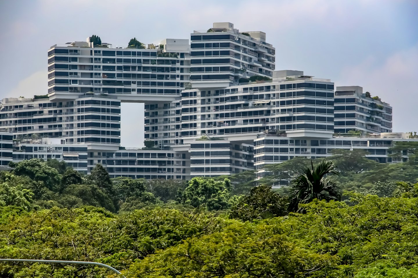 Modern residential building with block architecture and green rooftops.