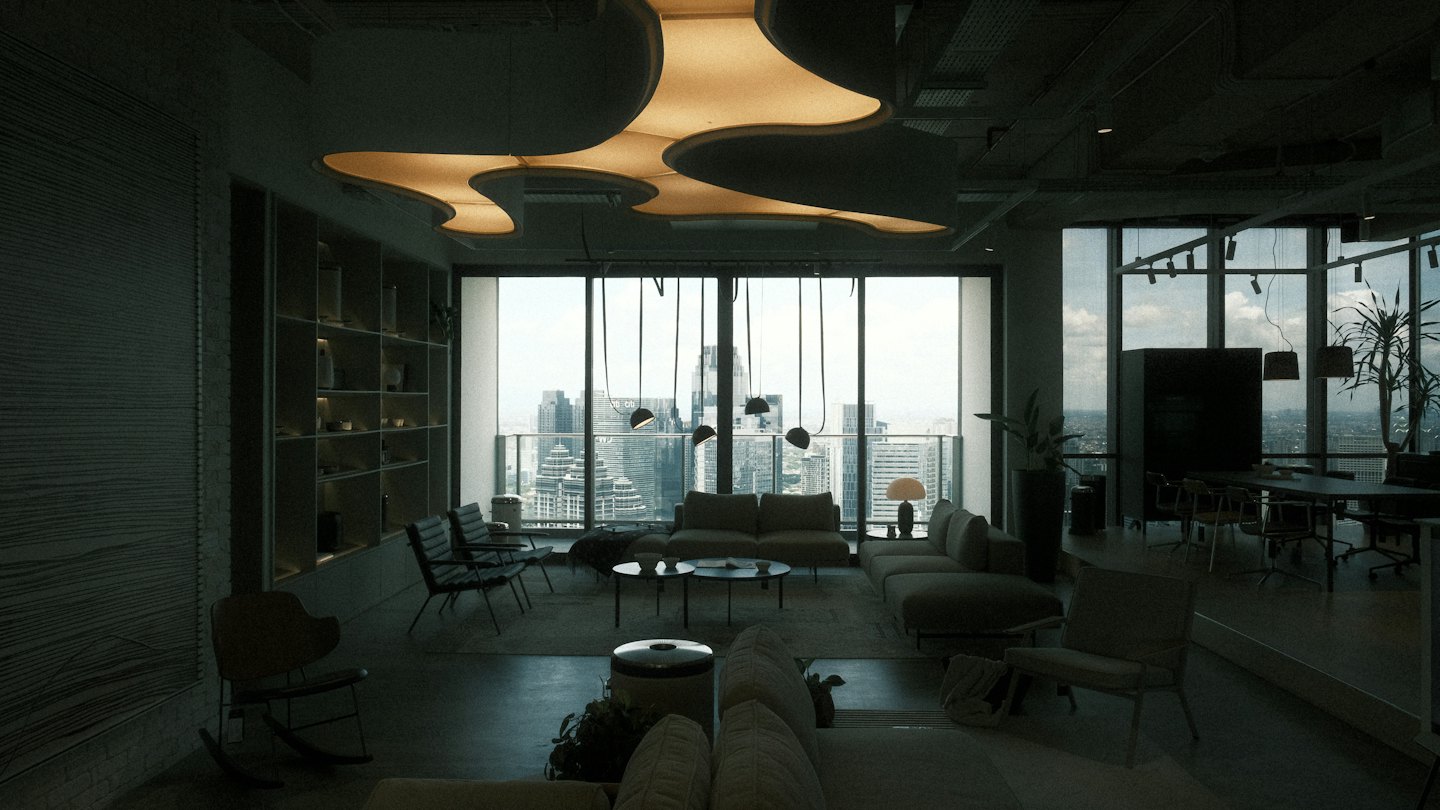 Modern office lounge with sofas overlooking a city skyline.
