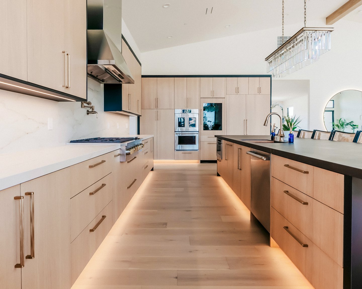 Modern kitchen with wooden cabinets and a marble island.
