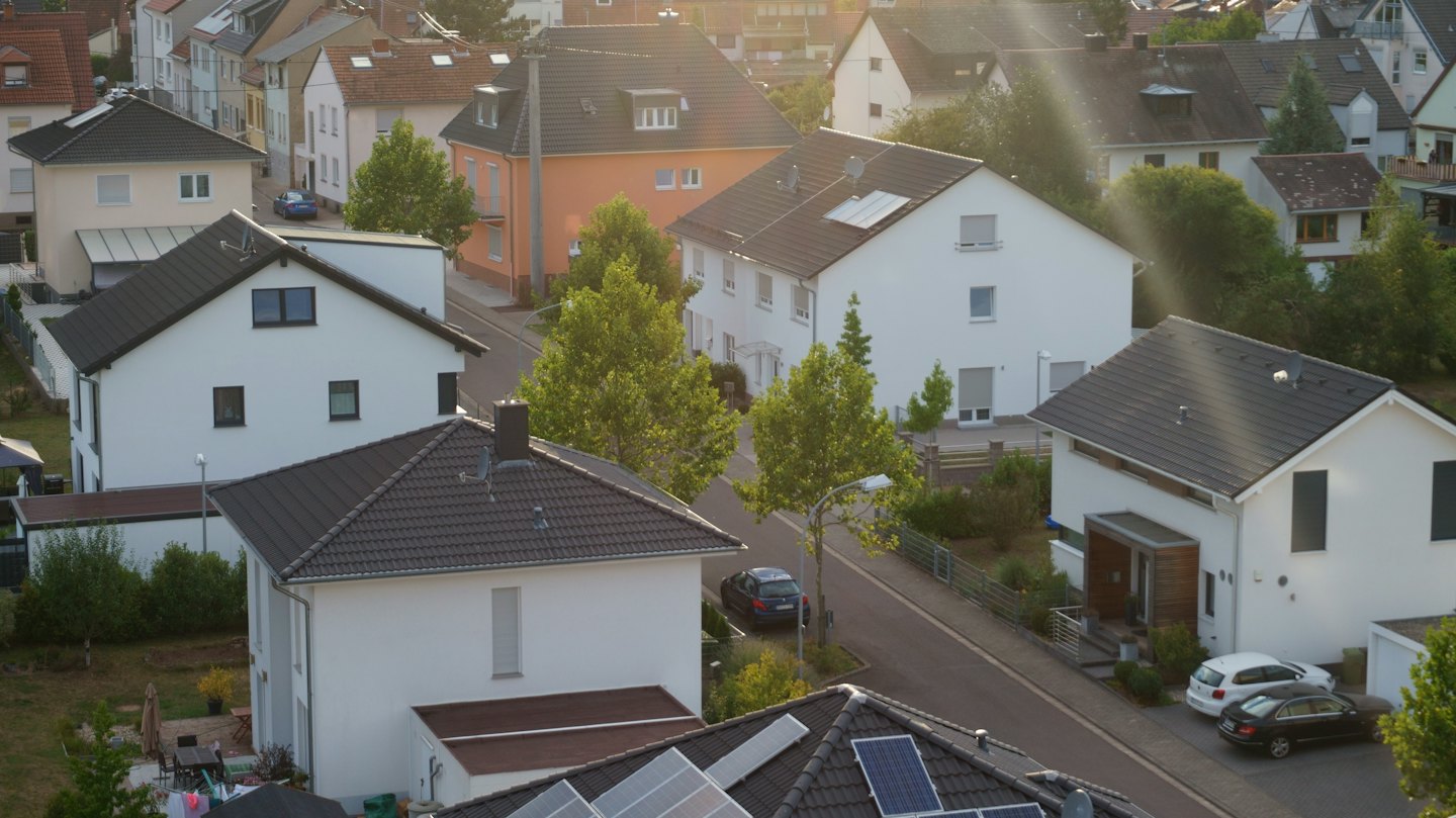 Suburban neighborhood aerial view with modern houses and solar panels.
