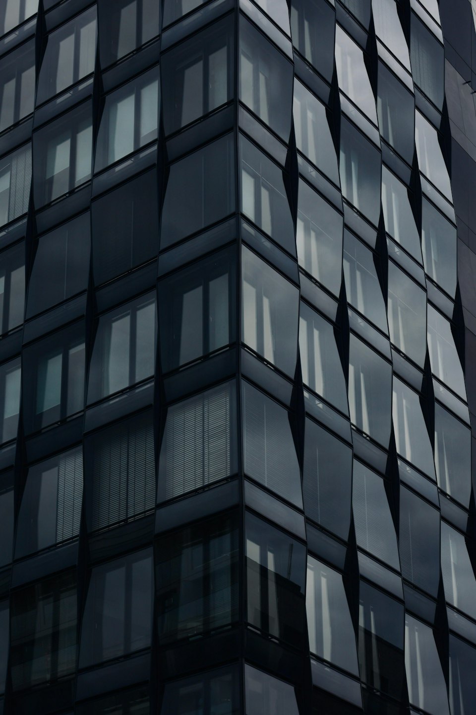 Modern building facade with geometric glass panels.